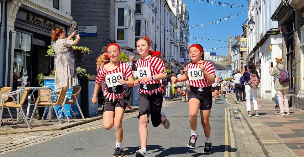 Three girls wearing pirates outfits taking part in the pirates fun run 2024